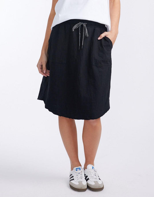 Image of a model wearing Skirts. Product name - Signature Skirt Black in Black colour by brand - White & Co.