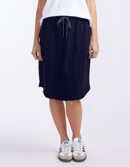 Image of a model wearing Skirts. Productname: Signature Skirt - in Navy colour by brand - White & Co.