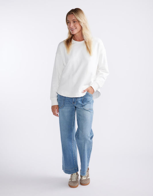 Image of a model wearing Outerwear. Productname: Staple Scoop Hem Sweat - in White colour by brand - White & Co.