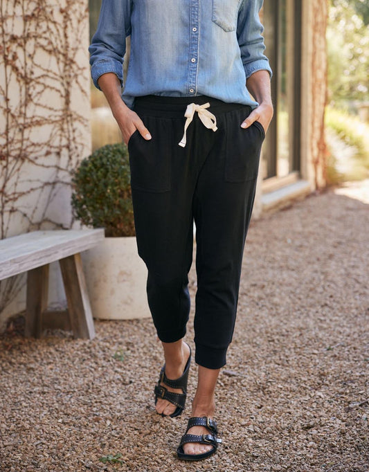 Image of a model wearing Pants. Productname: The Sunset Pant - in Black colour by brand - White & Co.