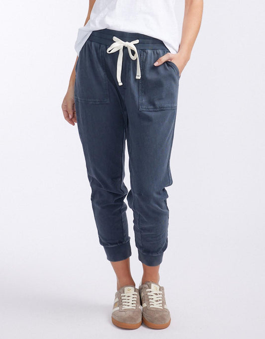 Image of a model wearing Pants. Productname: The Sunset Pant - in Washed Navy colour by brand - White & Co.