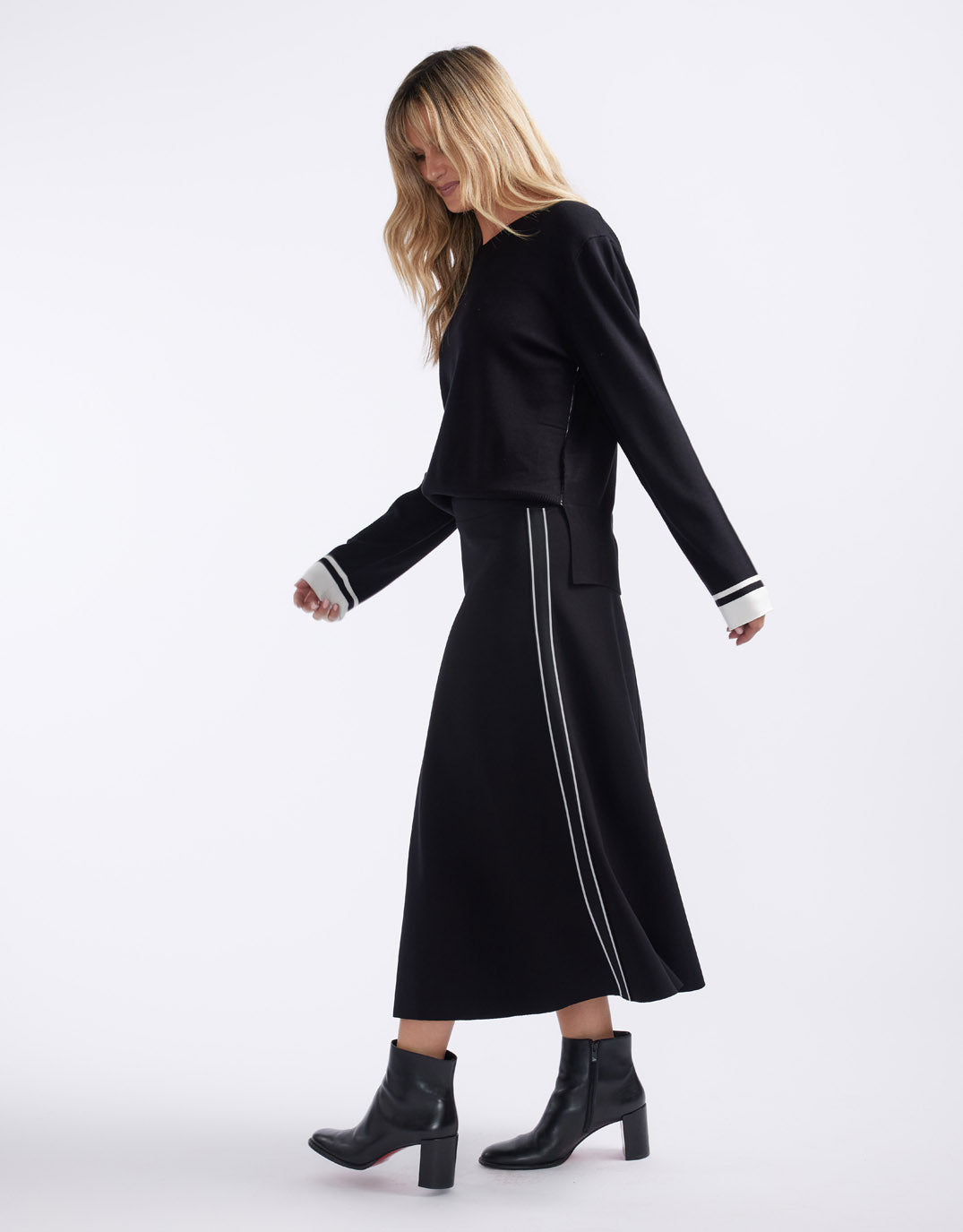 Image of a model wearing Skirts. Product name - Timeless Ponte Midi Skirt French Tape in French Tape colour by brand - White & Co.