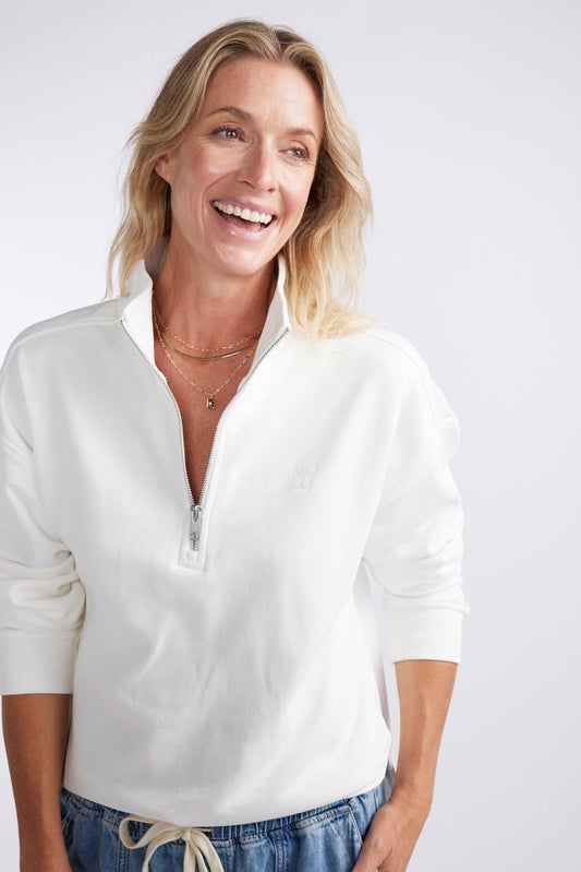 Image of a model wearing Outerwear. Productname: Unwind Half Zip Sweater - in White colour by brand - White & Co.