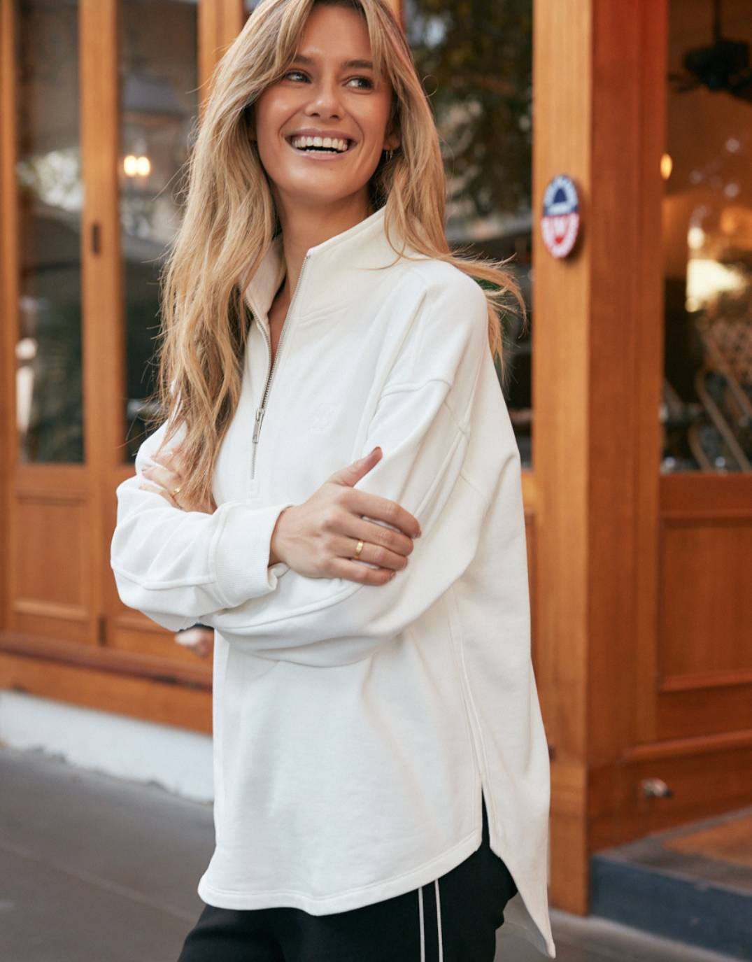 Image of a model wearing Outerwear. Productname: Unwind Half Zip Sweater - in White colour by brand - White & Co.