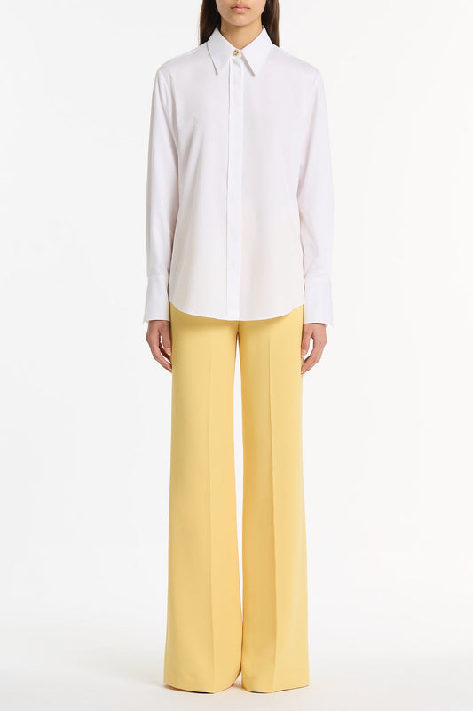 Image of a model wearing Tops. Product name - White Cotton Relaxed Shirt in White colour by brand - Carla Zampatti