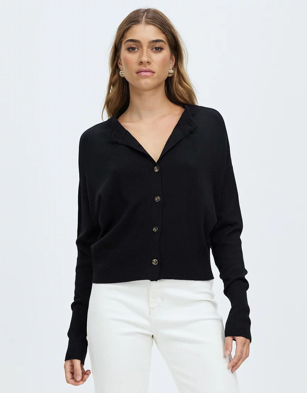 Image of a model wearing Outerwear. Productname: Dacey Cardigan - in Black colour by brand - White by FTL