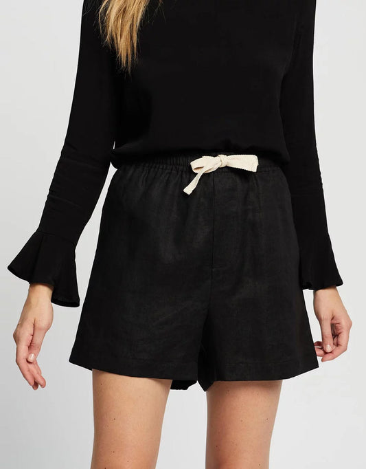 Image of a model wearing Shorts. Productname: Weston Linen Shorts - in Black colour by brand - White by FTL