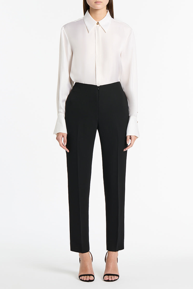 Image of a model wearing Tops. Product name - White Silk Twill Relaxed Shirt in White colour by brand - Carla Zampatti