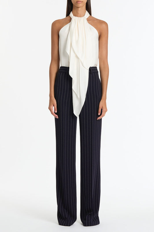 Image of a model wearing Tops. Product name - White Silk Twill Ruffle Halter Top in White colour by brand - Carla Zampatti