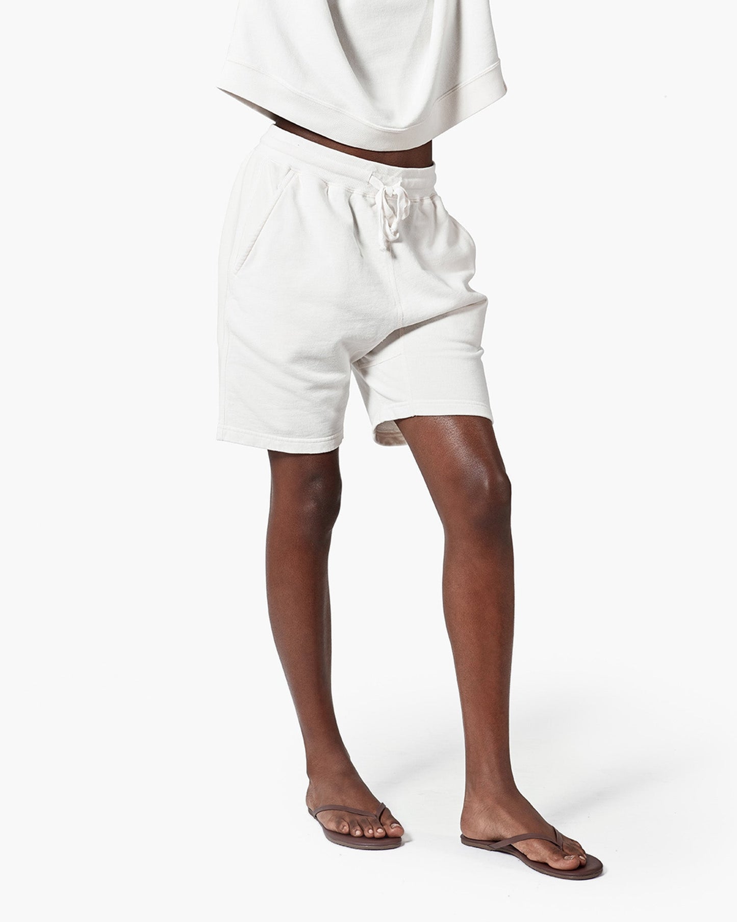 Image of a model wearing Shorts. Productname: Core Short Cream in Cream colour by brand - TKEES