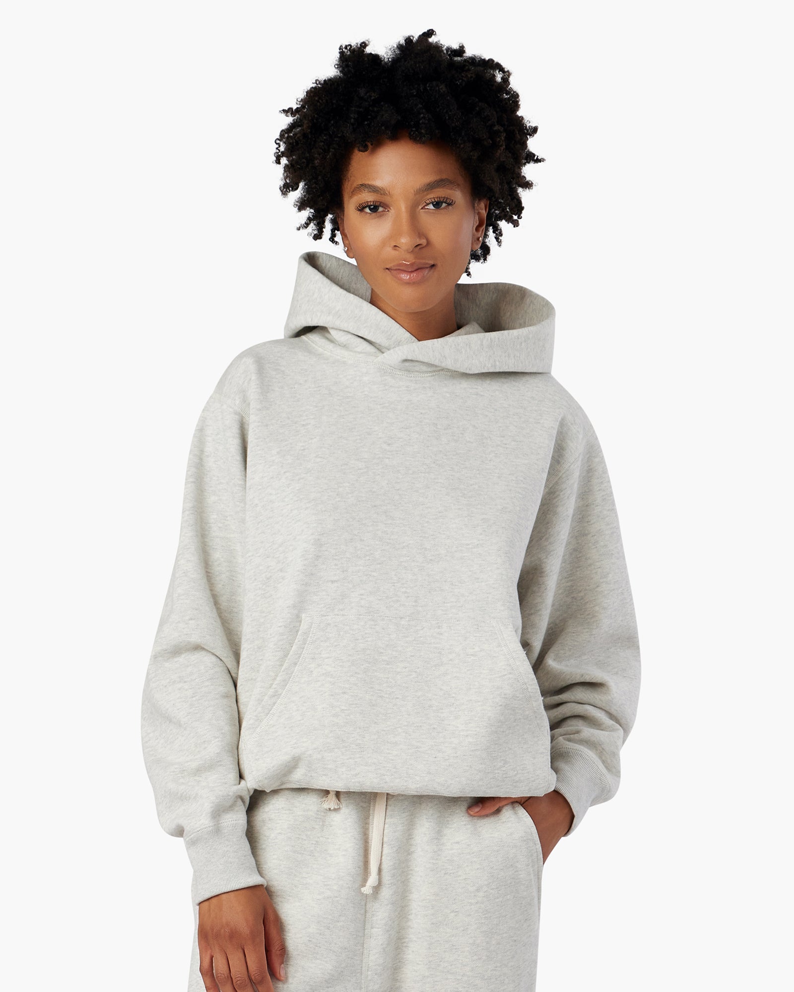 Image of a model wearing Outerwear. Productname: Core Fleece Hoodie Eggshell Mix in Eggshell Mix colour by brand - TKEES