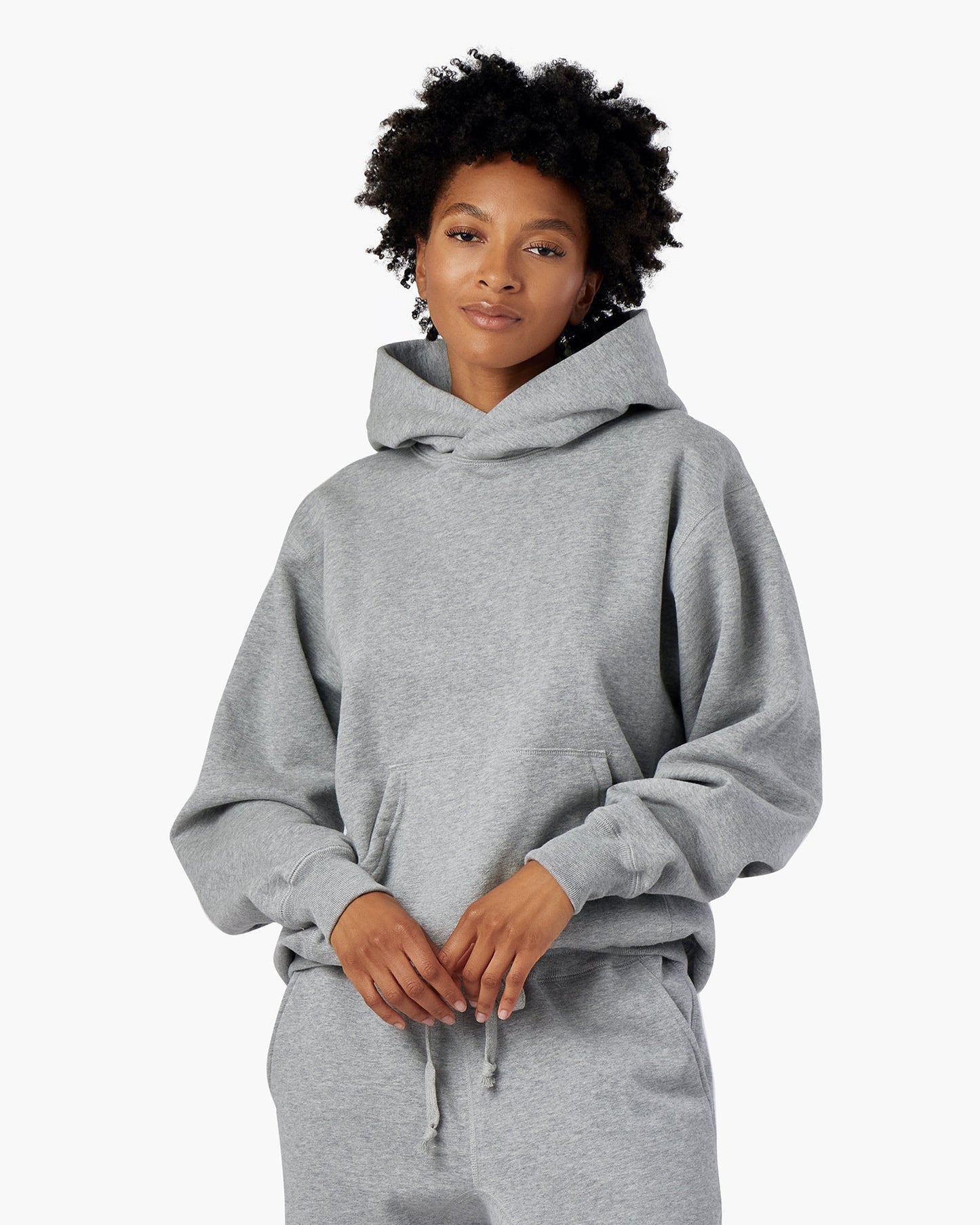 Image of a model wearing Outerwear. Productname: Core Fleece Hoodie Grey Mix in Grey Mix colour by brand - TKEES