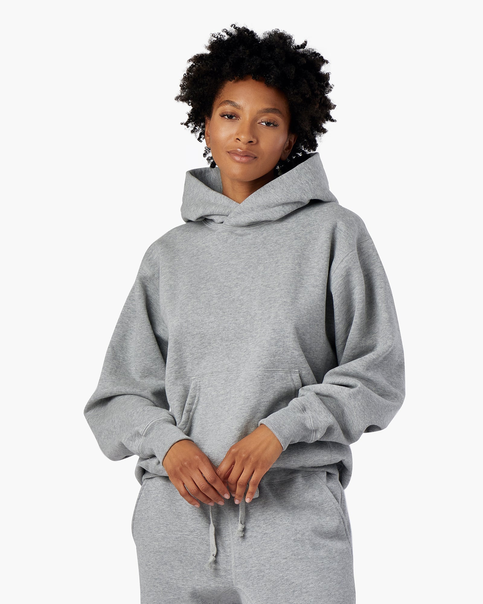 Image of a model wearing Outerwear. Productname: Core Fleece Hoodie Grey Mix in Grey Mix colour by brand - TKEES