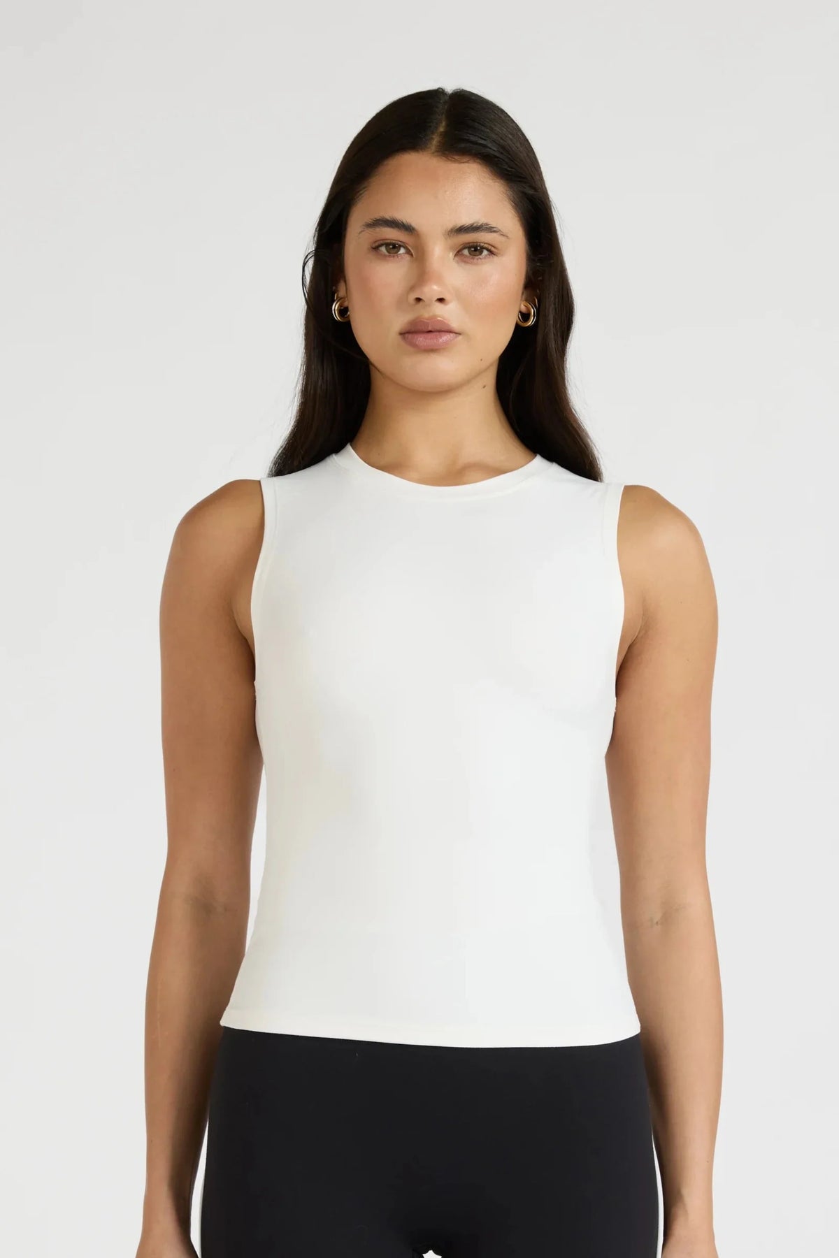Image of a model wearing Tops. Product name - ALLFENIX CloudCore Lite Active Tank in White colour by brand - All Fenix