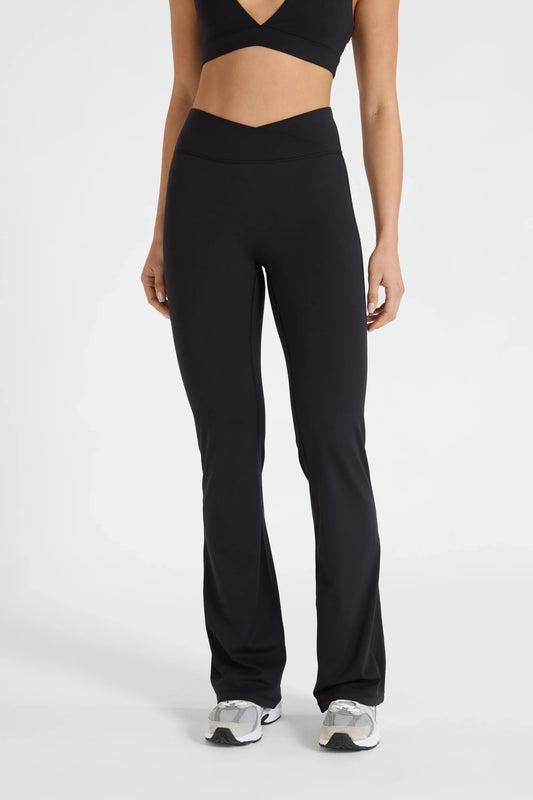 Image of a model wearing Pants. Product name - ALLFENIX CloudCore V-Waist Flared Legging in Red colour by brand - All Fenix