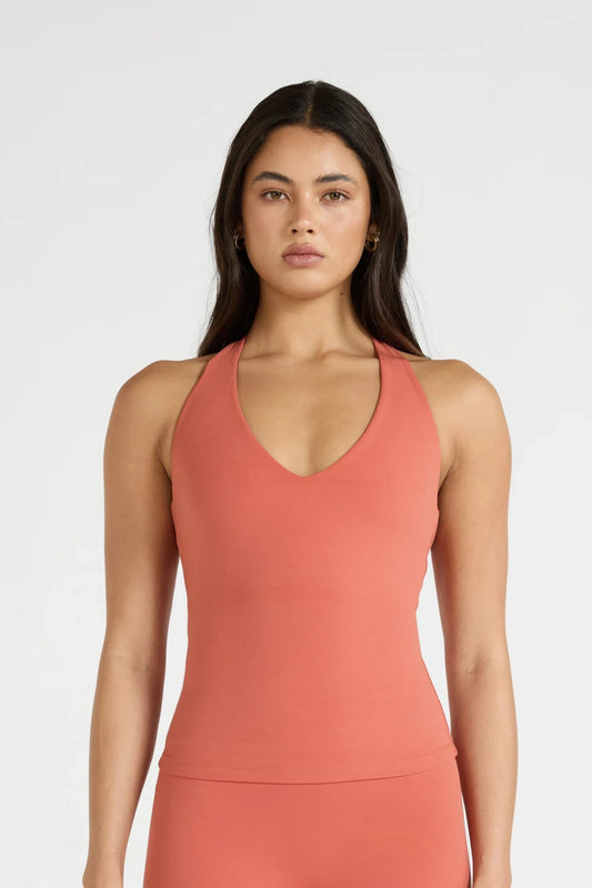 Image of a model wearing Tops. Product name - ALLFENIX CloudCore Plunge Tank in Tan colour by brand - All Fenix